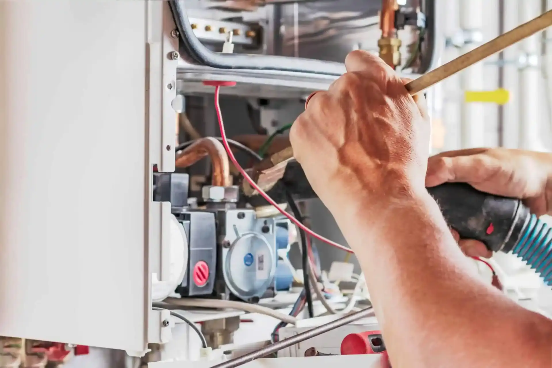 Therma Tech technician adjusting a smart thermostat in a customer's home
